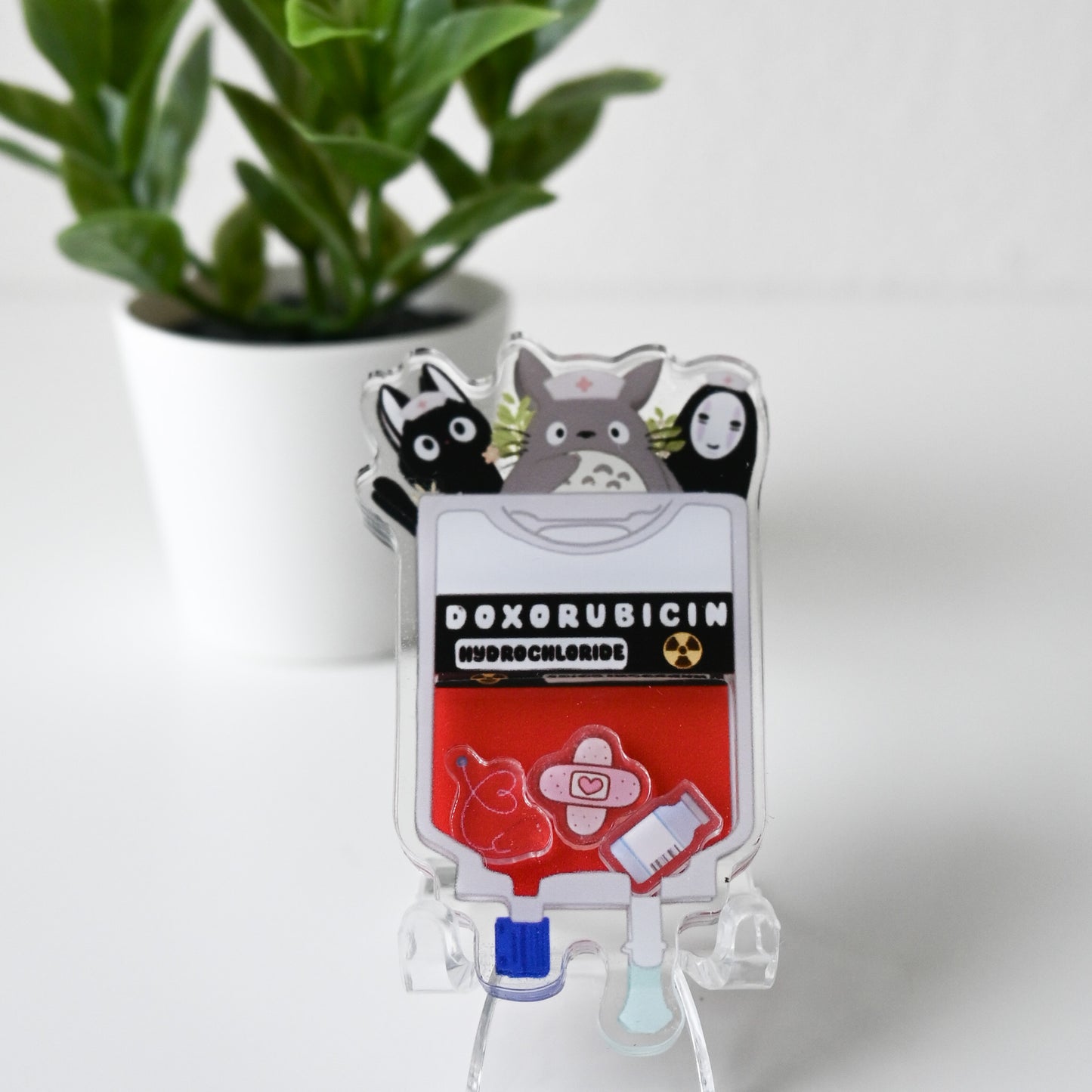 ONCOLOGY GHIBLI THEMED ACRYLIC SHAKER BADGE REEL