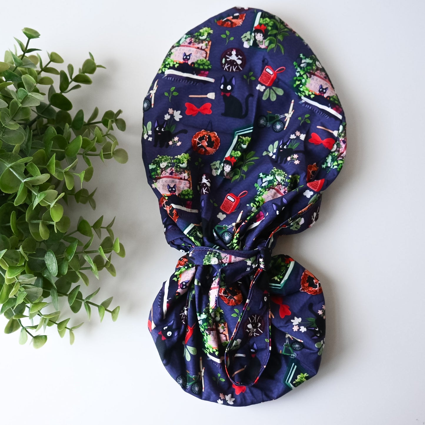 KIKI'S DELIVERY SERVICE - PURPLE JIJI WITH PLANTS SATIN LINED PONYTAIL SCRUB CAP