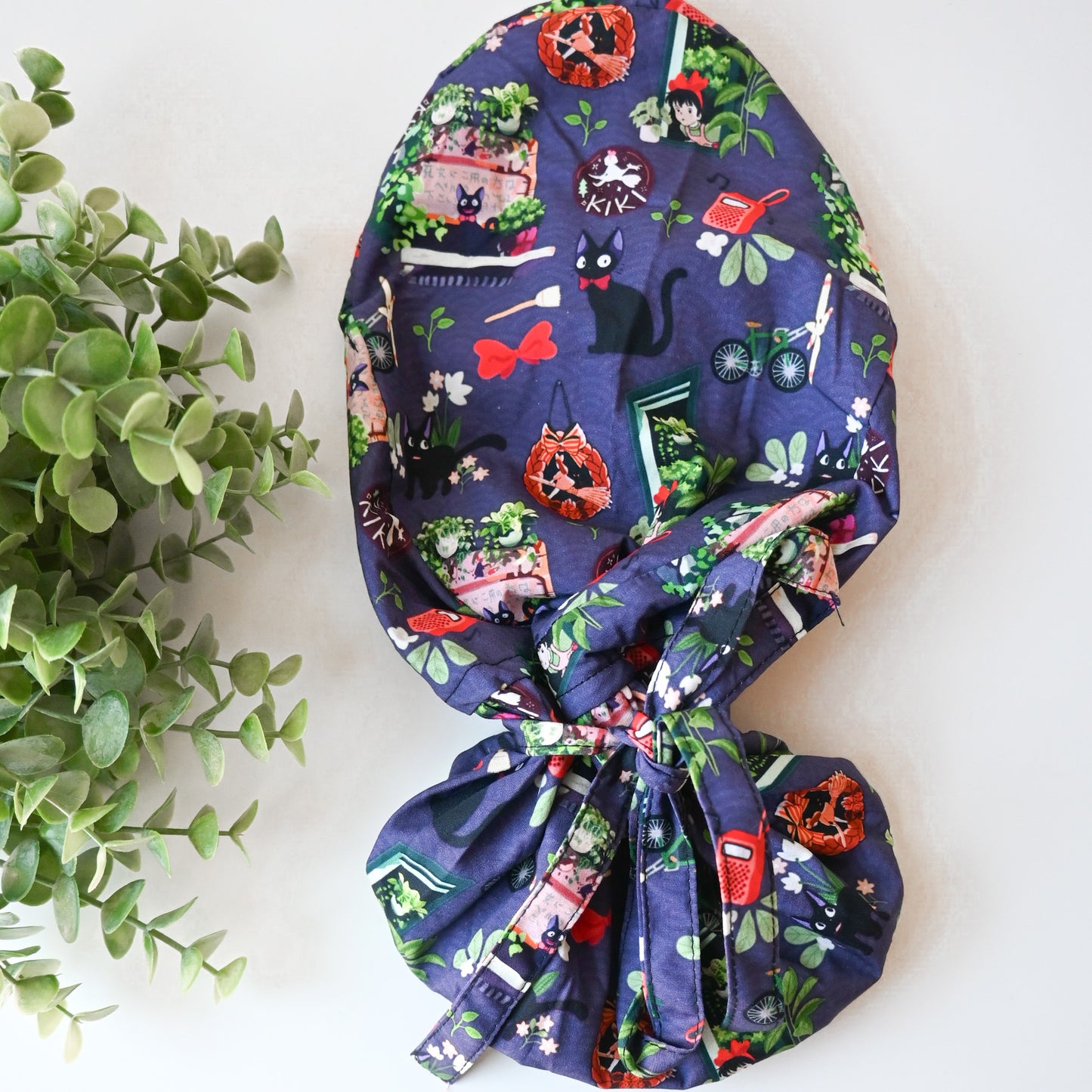 KIKI'S DELIVERY SERVICE - PURPLE JIJI WITH PLANTS SATIN LINED PONYTAIL SCRUB CAP